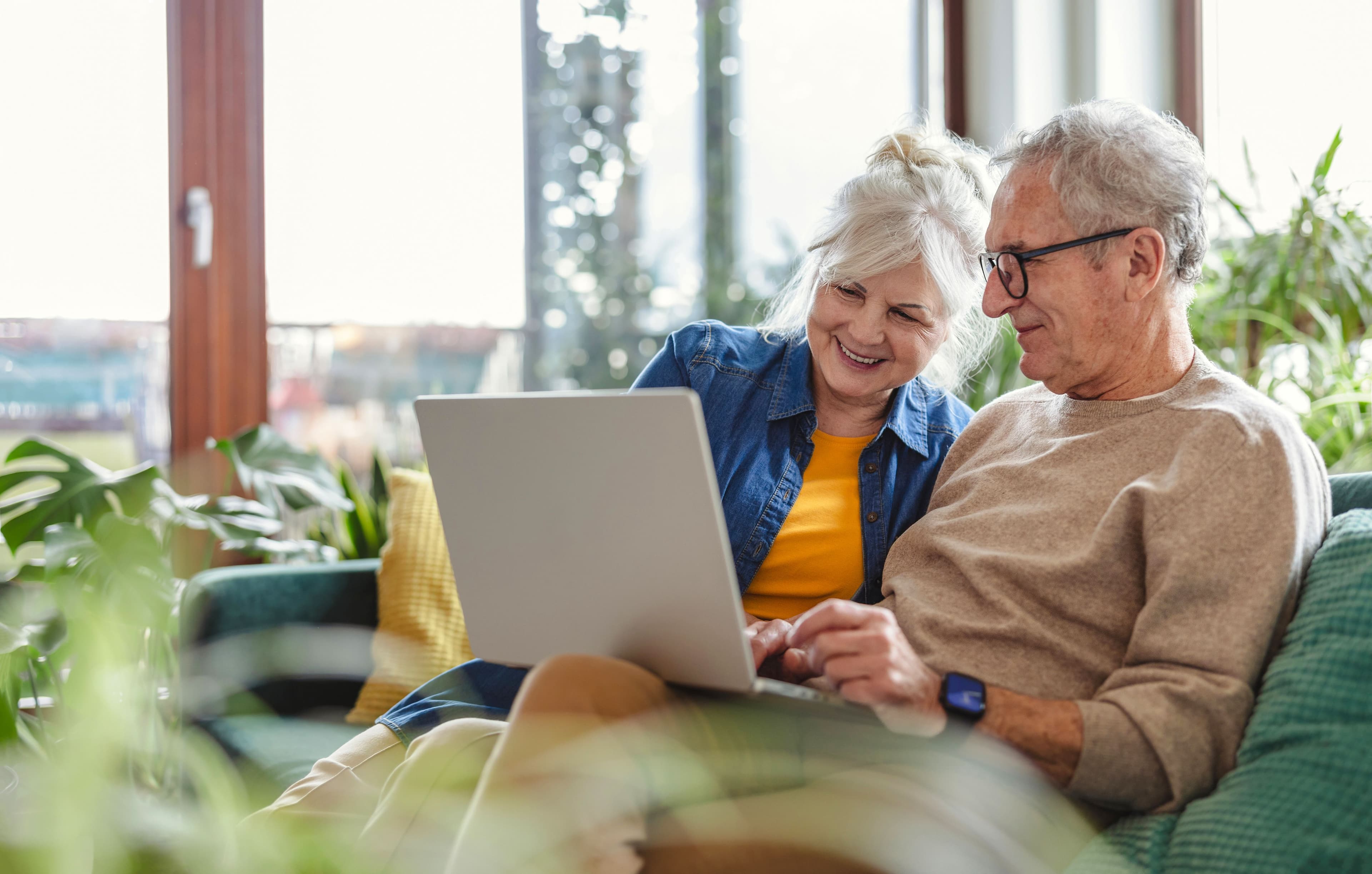Couple look at laptop together